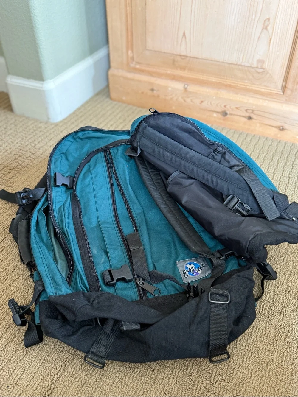 Teal and Black Vintage Eagle Creek Backpack with a day pack attached.